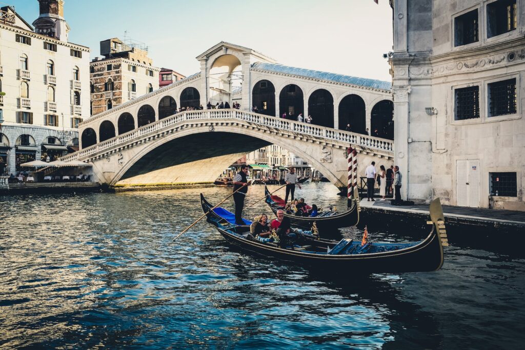 The Rialto Bridge is an iconic symbol of Venice, Italy, known for its beautiful architecture and bustling market atmosphere.